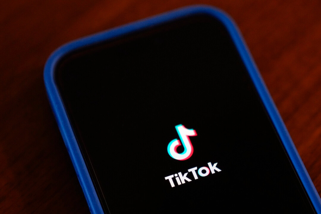 Image the Tik Tok logo on a dark screen on a phone