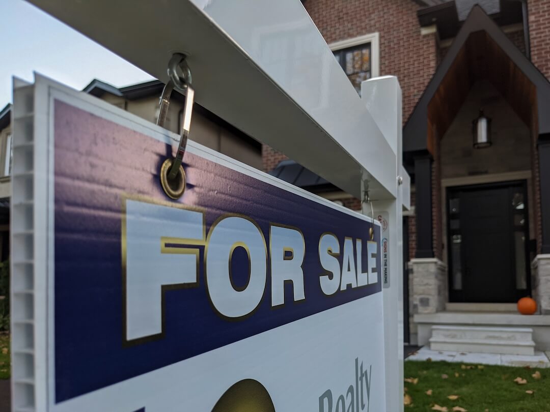 Toronto Canada Oct 19 2021: Sign for sale in front of a detached house in residential area. Real estate bubble, new listings, hot housing market, overpriced property, overpaid, buyer activity concept