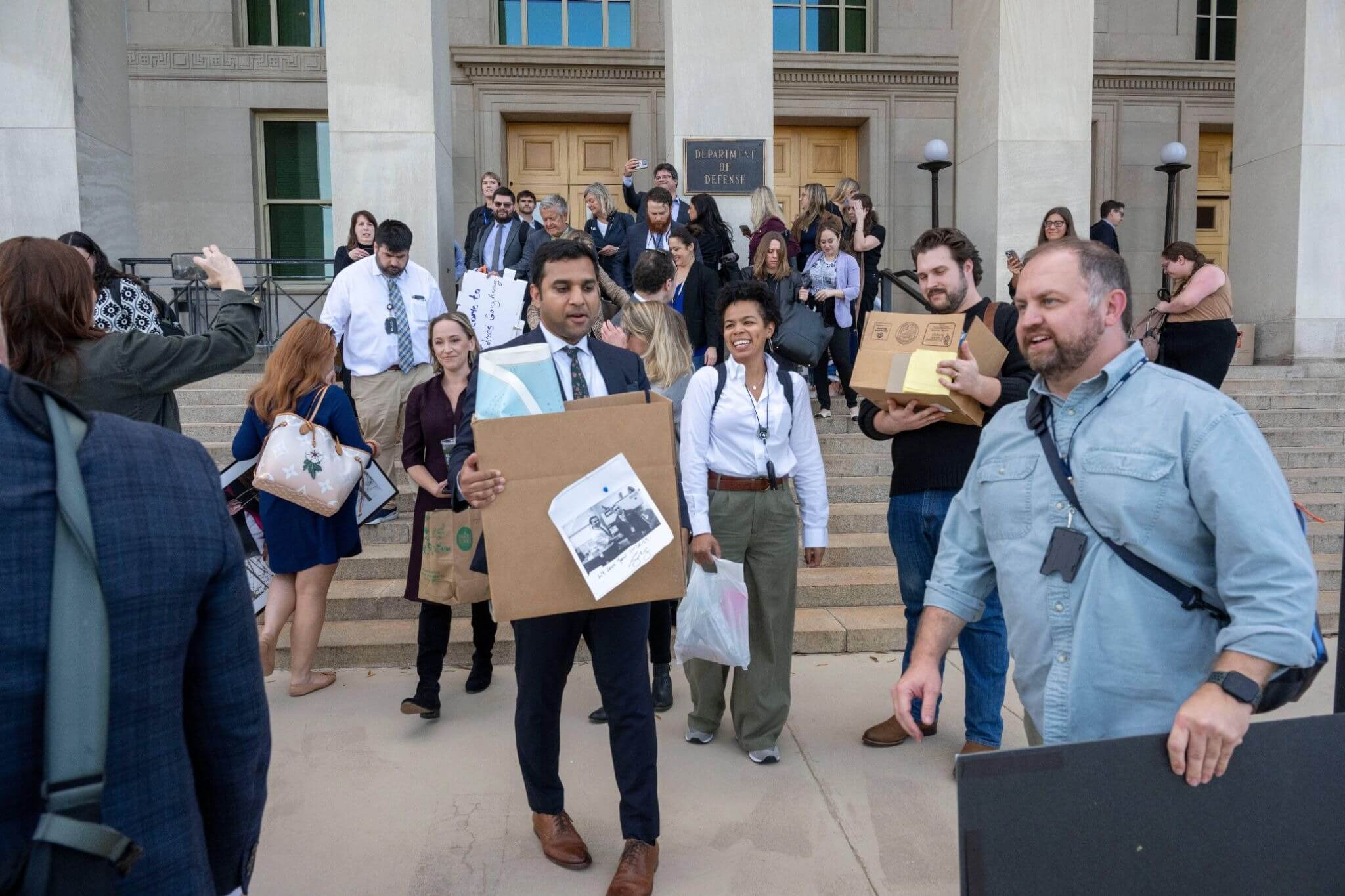Many journalists walk out of the Pentagon with their work belongings