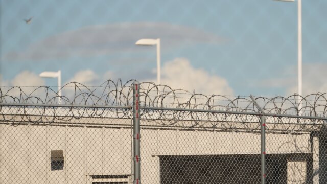 Barbed wire is seen through chain link fences at the Northwest U.S. Immigration and Customs Enforcement Processing Center, Aug. 13, 2025, in Tacoma, Wash.