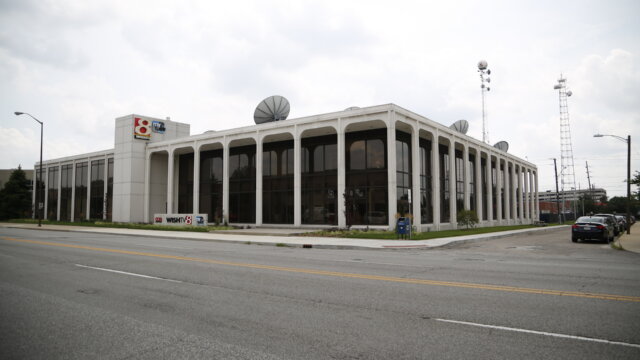 A large, white building with dark windows