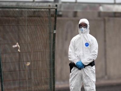 A Civil Guard border police stands guard following the arrival of hantavirus-stricken cruise ship MV Hondius at the port of Granadilla in Tenerife, Canary Islands, Spain, Sunday, May 10, 2026. (AP Photo)