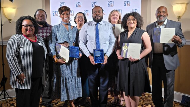 Group of reporters, editor, and publisher from the Indianapolis Recorder newspaper holding awards.
