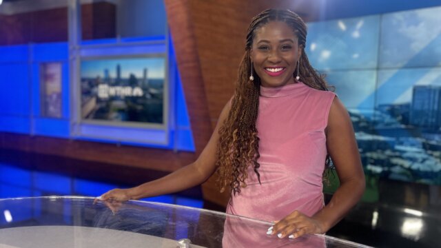 African American female news anchor posing at the WTHR news desk.